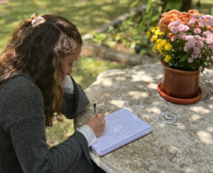 Person journaling at the garden